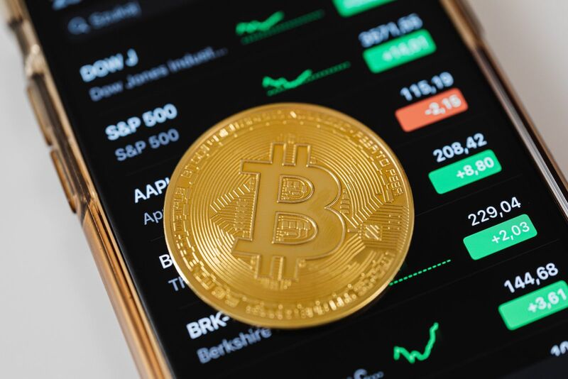 Crypto - Bitcoin on Phone Stock Prices Background